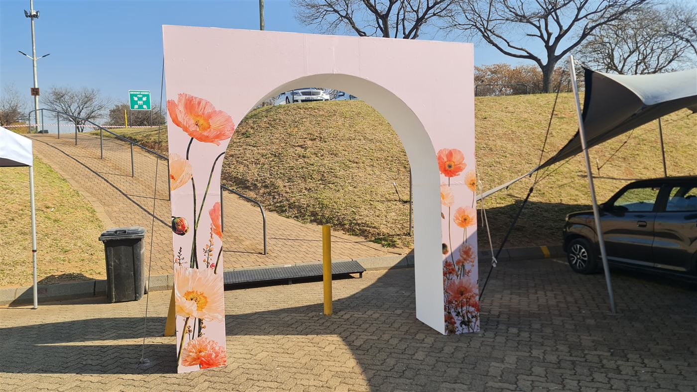 Outdoor floral gateway arch event backdrop