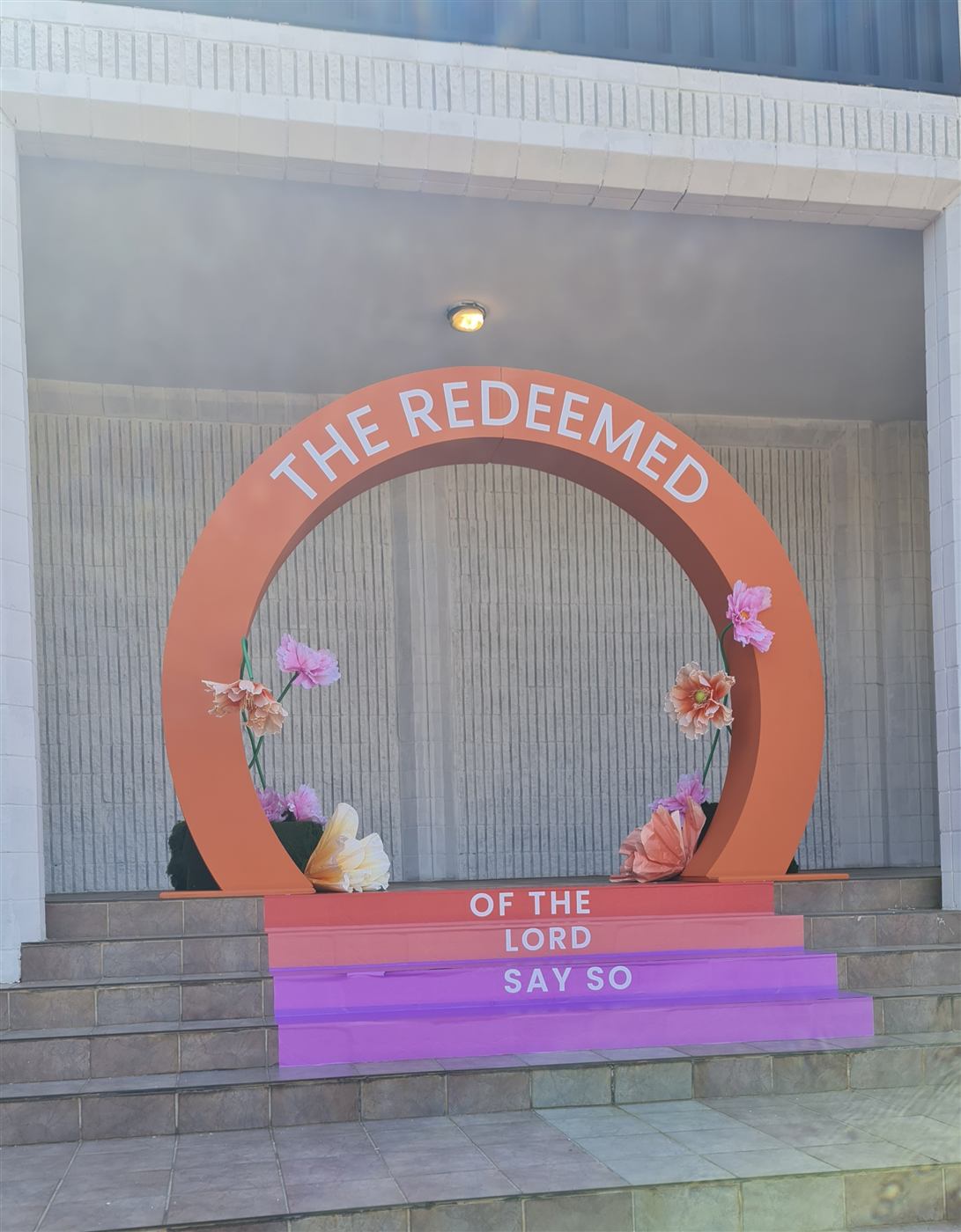 Large circular arch event backdrop with paper flowers
