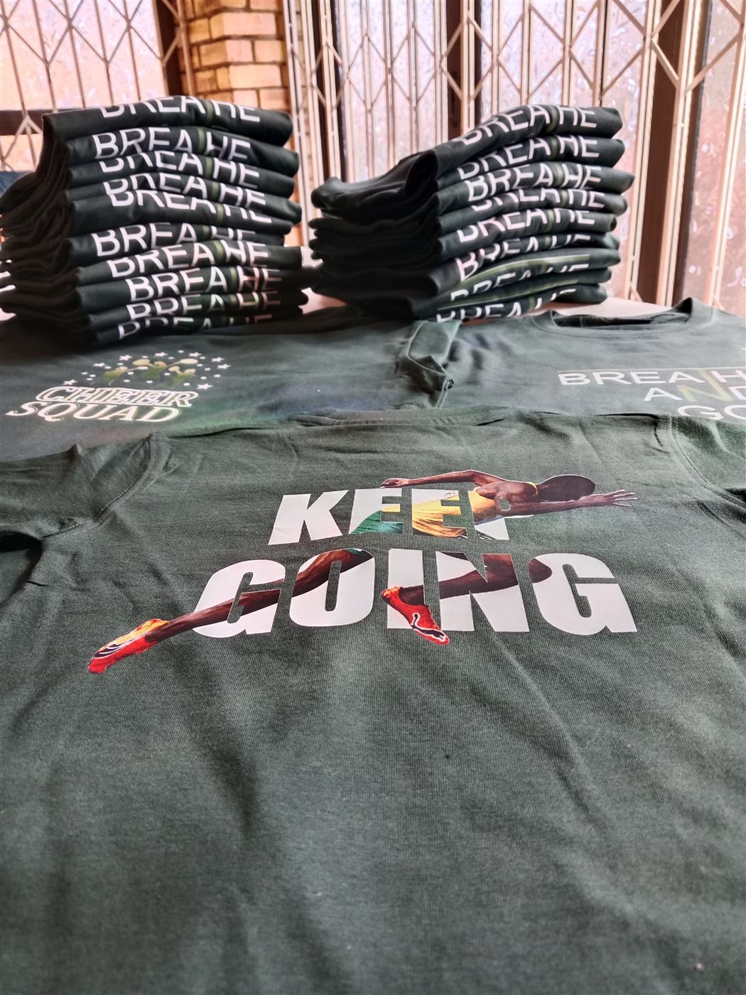 Custom printed branded t-shirts stacked and ready for delivery