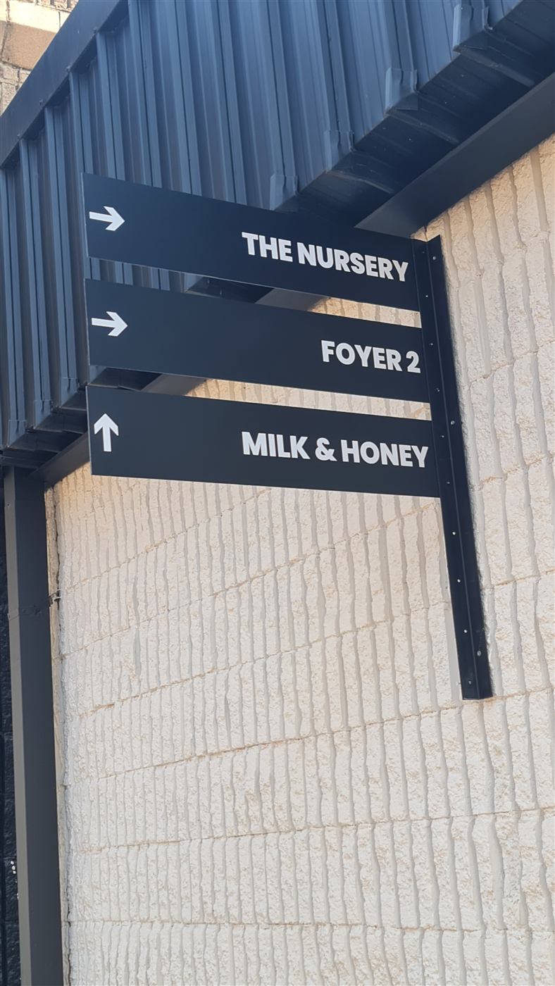 Directional wayfinding signage for Rhema Church nursery and Milk and Honey room